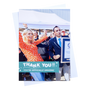 an a5 portrait thank you post card with a holding image of someone celebratin their new world record with envelope