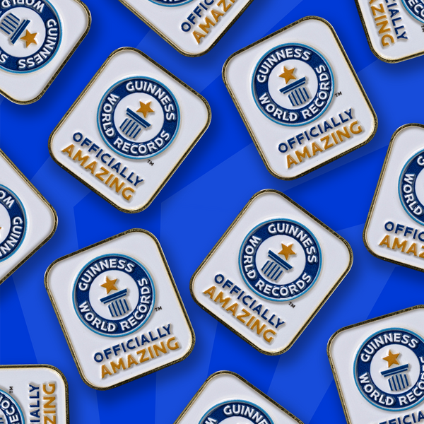 multiple Officially Amazing pin badges scattered across blue background